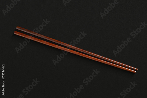 Pair of reusable chopsticks on dark background