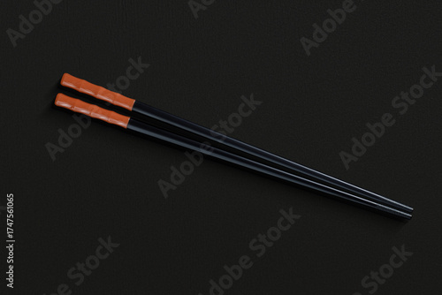 Pair of reusable chopsticks on dark background