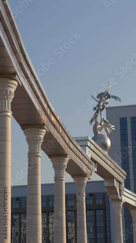Monument of the Stork on the Globe near columns at New Uzbekistan Park in Tashkent, Uzbekistan