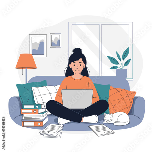 A woman works on her laptop while sitting on a couch with books and papers scattered around her.