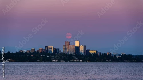 Bellevue skyline at sunset in a day to night timelapse, as the full moon rises and casts a golden glow over the city.