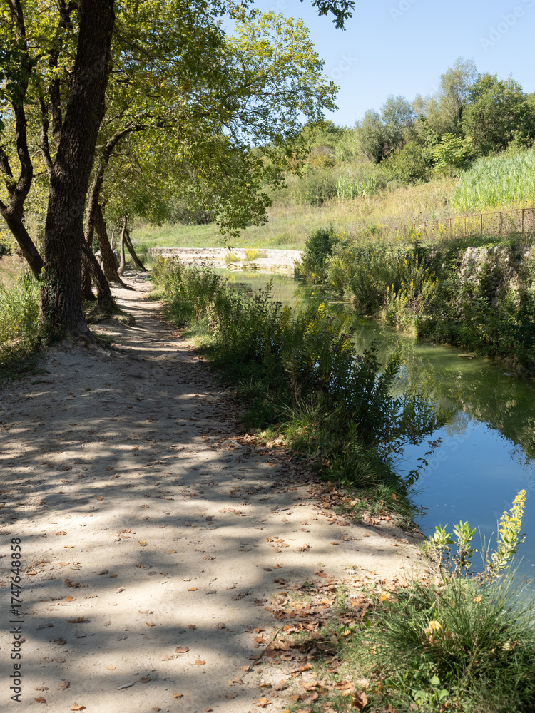 Obraz premium Parco naturale dei Mulini, public park with hot springs and dismantled system of grain mills at Bagno Vignoni, town in the province of Siena, Italy