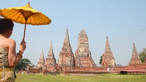 Thailand, Ayutthaya - march 15th, 2023: Woman in traditional Thai dress pose sightseeing visit ancient Buddha statue.Ayutthaya historical park. UNESCO World Heritage Site