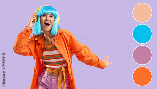 Beautiful young happy woman in blue wig and headphones on purple background