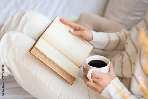 Young woman holding cup of ...