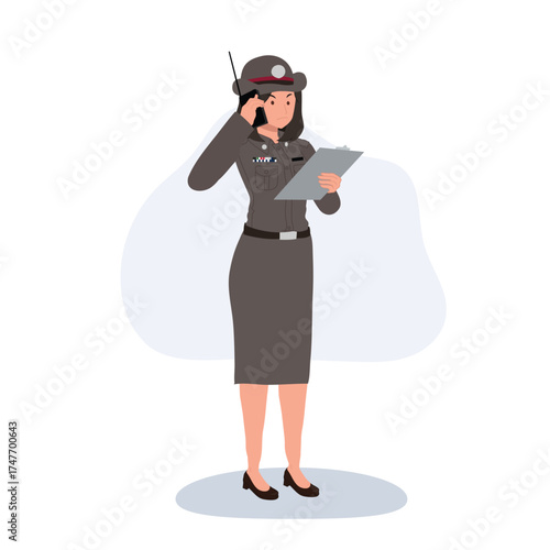 female police officer using radio and writing report in uniform for law enforcement and security duties in thailand