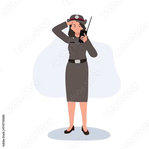 woman police officer in thai uniform talking on radio standing confidently representing duty and authority in security service