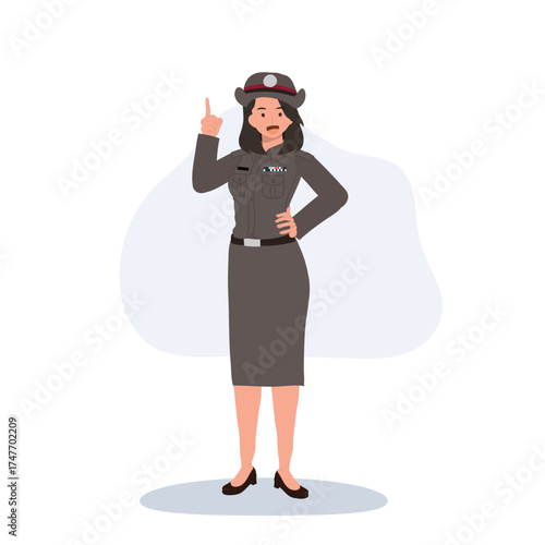 thai female police officer in uniform standing and pointing upward for public awareness or education concept