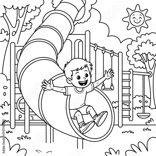 Happy boy sliding down a tube slide on a sunny day