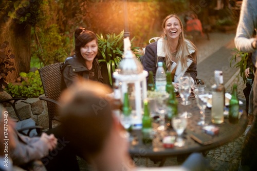 friends at table full of bottles of garden party