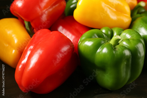 Fresh colorful bell peppers on wooden background, closeup