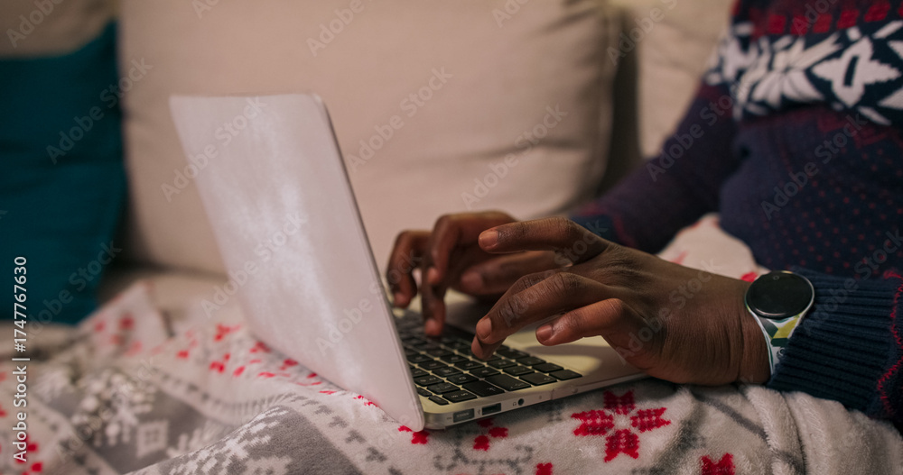 Φωτογραφία A close-up of the hands of a young man of multi-ethnic background typing on a laptop keyboard
