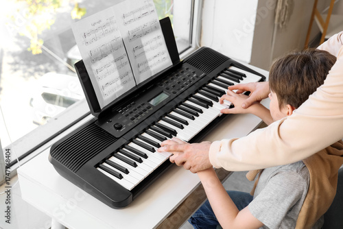 Cute boy learning to play s...