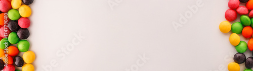 Foto Colorful candy border on a white background with copy space.