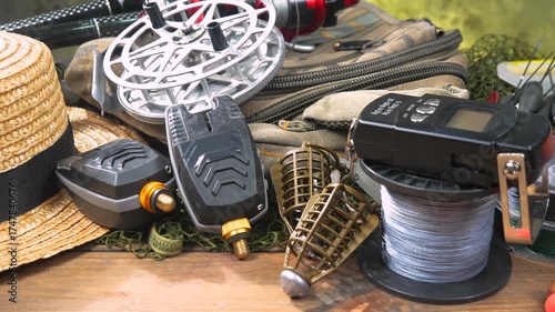 Sport fishing equipment on a table in a studio in a composition, against a background of a net.