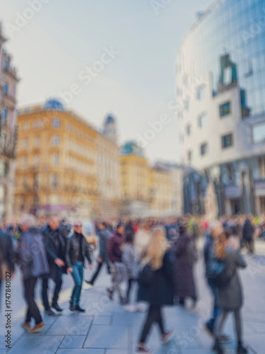 Crowd of anonymous people walking on busy city street