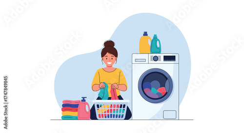 A woman happily sorts colorful clothes into a laundry basket next to a washing machine.