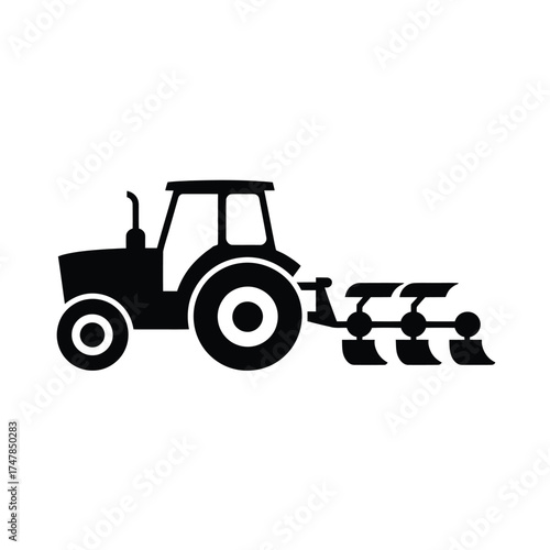 Black silhouette of a tractor plowing a field