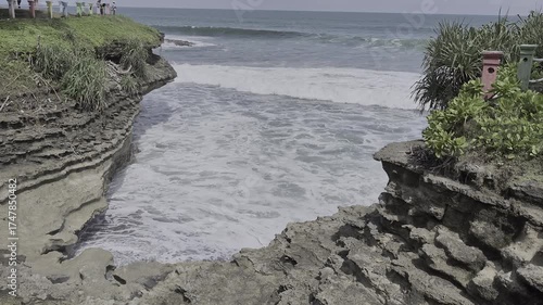 Ocean Waves Crashing into Cliff Grotto or Narrow Inlet