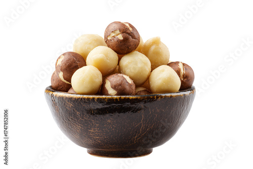 A rustic ceramic bowl filled with shelled and unshelled macadamia nuts.