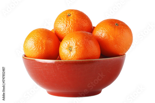 A rustic red ceramic bowl filled with fresh ripe oranges.