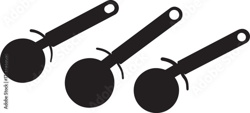 Three black kitchen spoons in a row with handles angled up isolated on white background silhouette