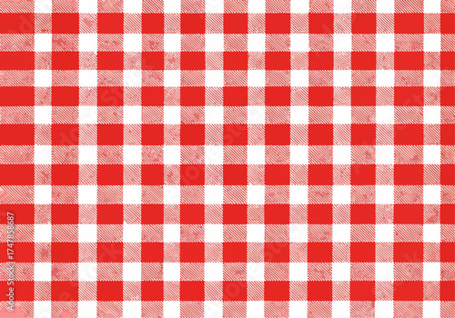 Red and white checkered picnic tablecloth on a fabric surface