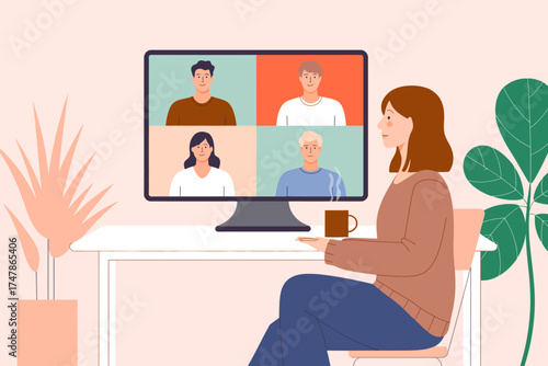 This image represents a woman participating in a virtual meeting, engaging with others on a video call displayed on her computer screen, capturing a collaborative environment.