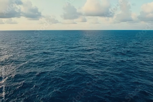 Tranquil Blue Ocean Under Soft Clouds in a Clear Sky