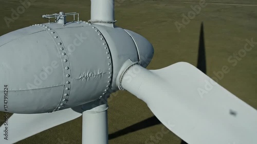 Aerial Close Up of a White Wind Turbine Spinning on Green Field Under Sunny Skies Windmill Generating Clean Energy with Rotor Blades Creating Renewable Electricity Supply 45