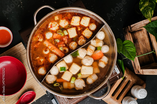 Fotografia Spicy Taiwanese hot pot with various steamboat included crab sticks, fish balls, and tofu