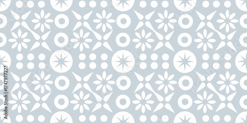 Seamless geometric pattern with white stylized flowers and starbursts on a pale blue background