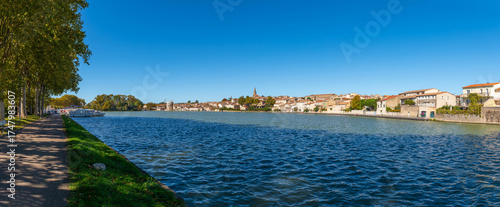 View of Castelnaudary with the Canal du Midi with its boats, from the quay of the Canelot, in Castelnaudary, in Aude, in Occitanie, France