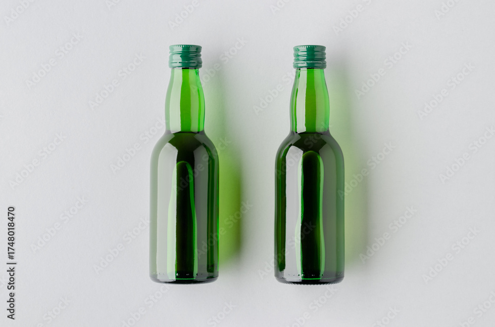 Fototapeta premium Miniature spirits, liquor bottle mockup, green glass.