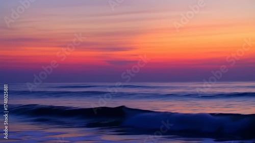 A serene seascape captures the fiery embrace of a sunset sky, reflecting on the gentle waves