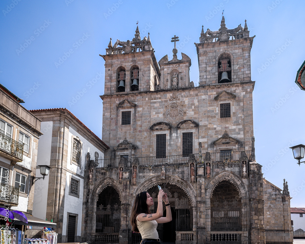 Fototapeta premium Woman traveling Braga, Portugal, photographing around Santa Maria de Braga Cathedral