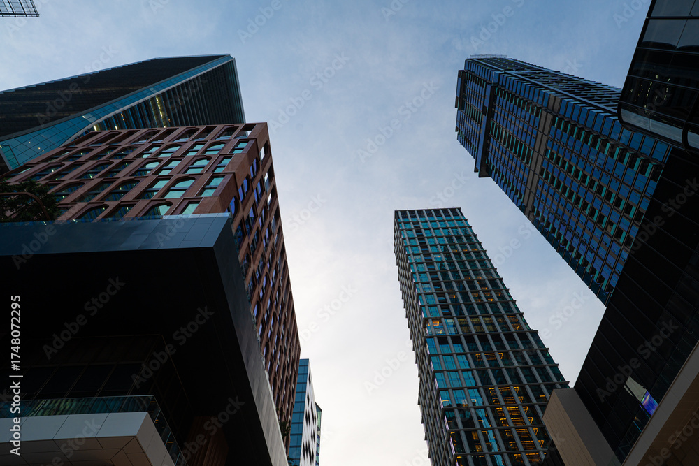 Naklejka premium Modern office building finacial district metropolis look up sky