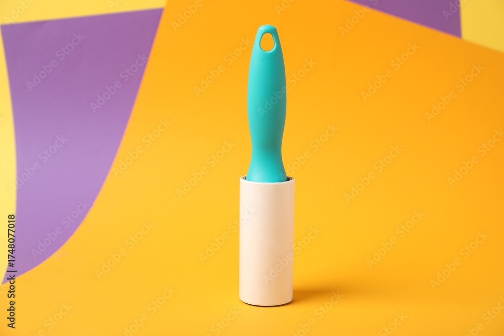 Fototapeta premium One sticky lint roller on color background