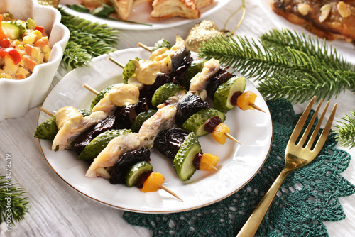 Herring fillet skewers with prune and pickles for Christmas