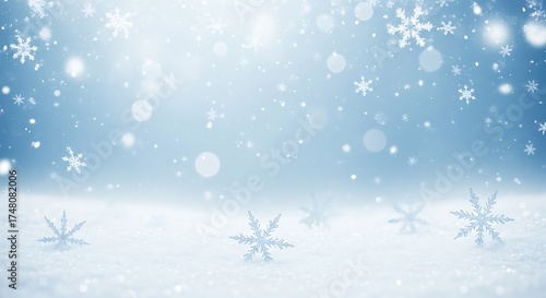 Gentle snowfall winter wonderland background with soft blue hues and falling snowflakes