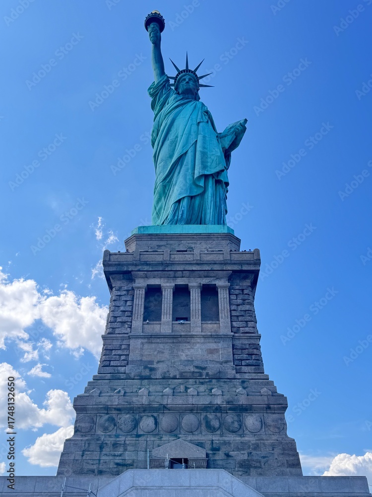 Fototapeta premium Iconic Statue of Liberty and Pedestal Viewed from Below on a Clear Summer Day