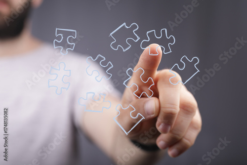 Hand pointing at puzzle pie...