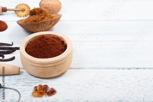 pile of cocoa powder, sugar and dessert ingredients, kitchen utensils on old white wooden