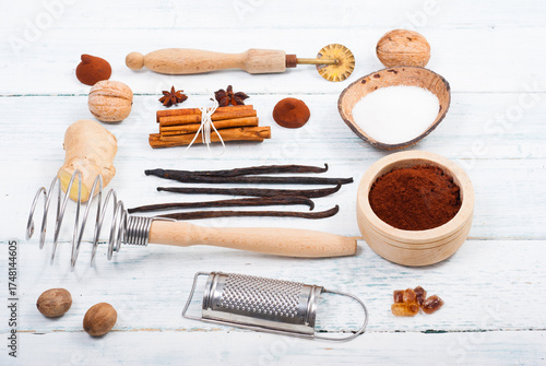 dessert ingredients and kitchen utensils on old white wooden table