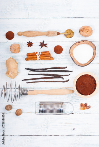 dessert ingredients and kitchen utensils on old white wooden table