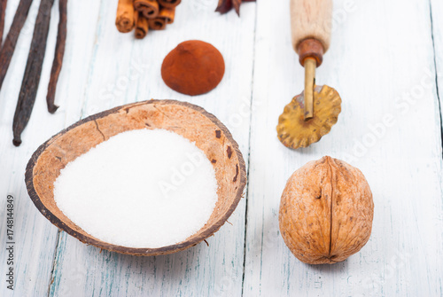dessert ingredients and kitchen utensils on old white wooden table