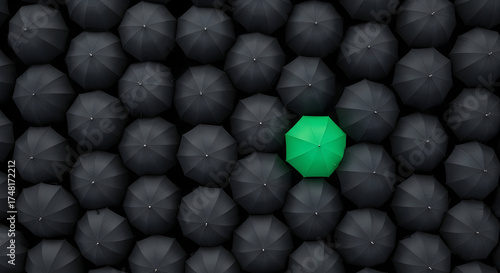Capture attention with this image showcasing individuality, a vibrant green umbrella amidst a sea of black, symbolizing uniqueness and standing out in the crowd.