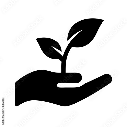 Hand holding a young plant, symbolizing growth