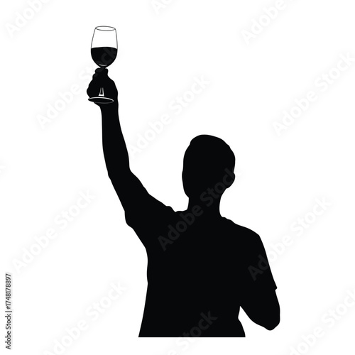 Silhouette of person holding up wine glass in celebration