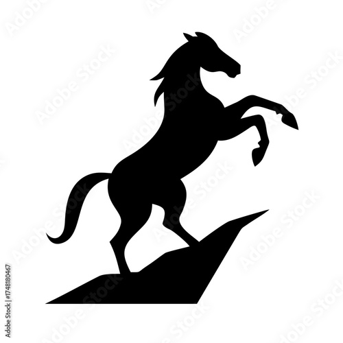 Silhouette of a rearing horse on a rock